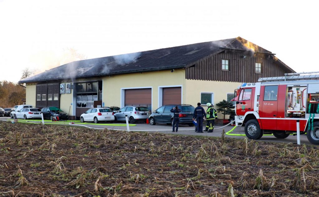 Three firefighters in a major fire at a car workshop in Satellite
