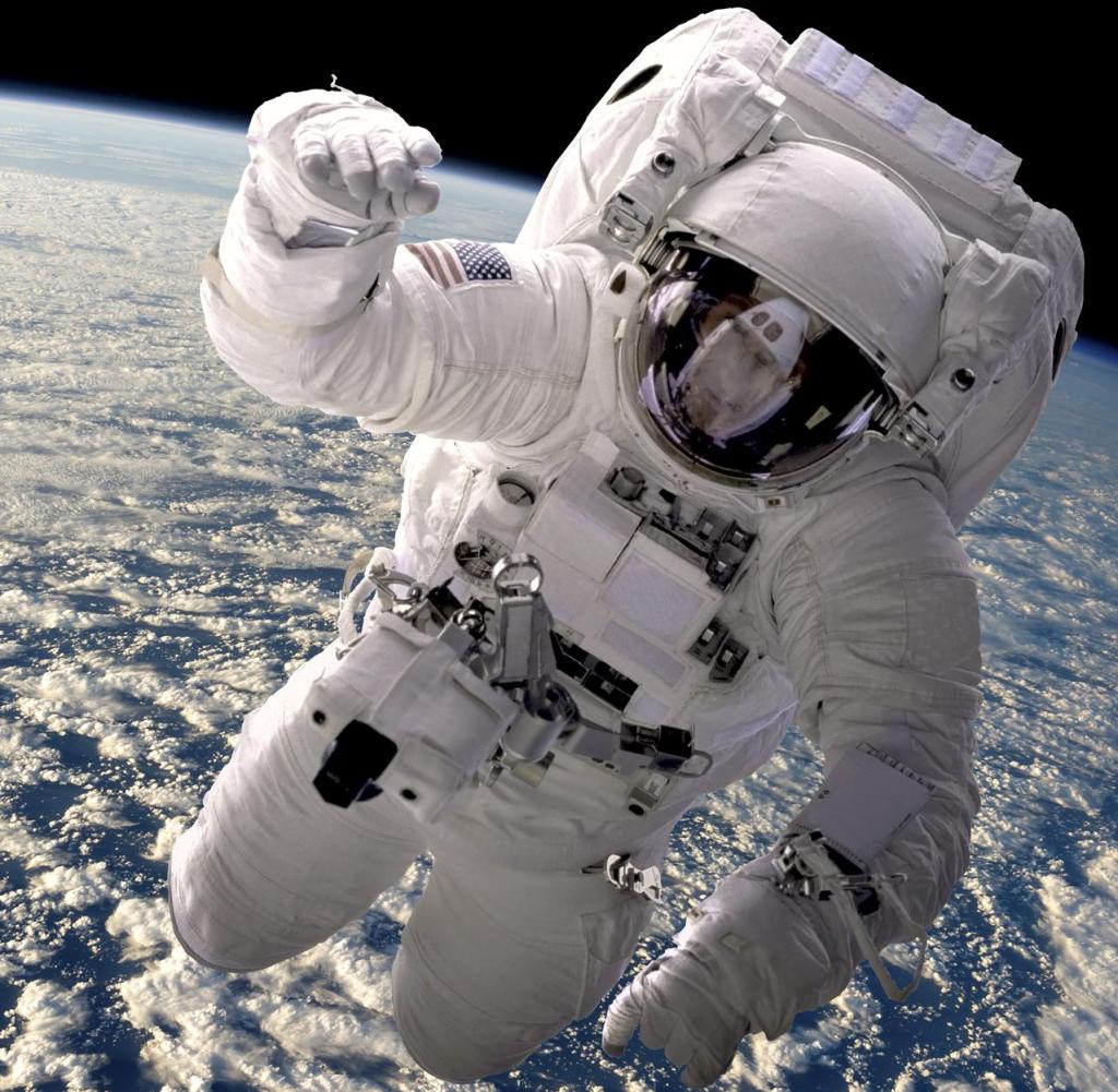 Artist's opinion of an astronaut floating in space.  The cloud-covered earth is below.