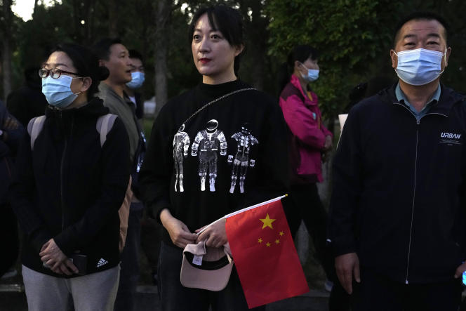 On Thursday, June 17, 2021, an astronaut wearing a space-themed shirt and holding the Chinese flag waits for Chinese astronauts to arrive at the Jiuquan Satellite Launch Center in Juan, northwest China, ready to board the liftoff.  China plans to launch on Thursday three astronauts aboard the Shenzhou-12 spacecraft, which will be the first crew members to live in China's new orbital space station Tianhe or Heavenly Harmony.  (AP Photo / Ng Han Quan)